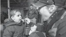  ??  ?? Two-year-old Alaa Alnajar gets a taste of genuine Canadian maple syrup.