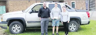  ?? THE CANADIAN PRESS ?? Twin Motors’s Kevin Mitchell, Dauphin Regional Comprehens­ive Secondary School student Zach Zurba, and teacher Patty Goodine stand next to the 2004 Chevy Avalanche truck, donated by Twin Motors, which Zurba won on Friday in a draw for students with...