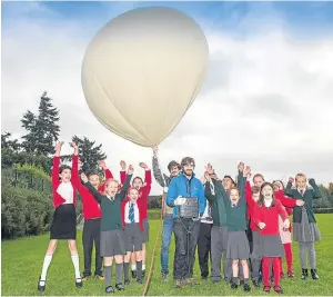  ?? Picture: PA. ?? Pupils from St Stephen’s and Newhill primary schools with scientists from Sent into Space who helped them launch the new polymer £10 note into the atmosphere.