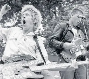  ?? CP PHOTO ?? Randall Desmond Archibald (left) known in Vancouver’s punk scene as Randy Rampage, and D.O.A. band-mate Joe Keithley play at Rock Against Racism at Chicago’s Lincoln Park in 1979 in this handout photo. Veterans of Vancouver’s music scene are expected to attend a memorial on Sept. 29 for punk pioneer Randall Desmond Archibald, known to hardcore rockers as Randy Rampage.