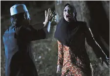  ??  ?? Scary success: Syamsul and Maya in a scene from ‘Munafik 2’.