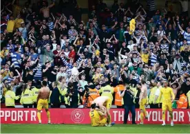  ?? Photograph: Matt West/Shuttersto­ck ?? Reading fans celebrate at the end of their win at Sheffield United as players’ shirts are thrown into the crowd.