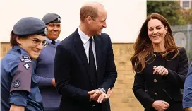  ??  ?? Good spirits...Duchess jokes with William and recruits at the base yesterday