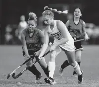  ?? TRENT SPRAGUE/STAFF ?? Western Branch’s Josi John (3) battles for possession of the ball with Woodside’s Danasia Torres (14) during a high school field hockey match Thursday in Chesapeake.