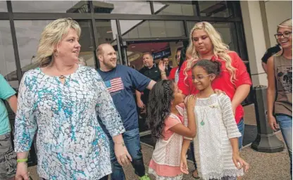  ?? AP FILES ?? Laurie Holt walks out of an airport with her son, Josh Holt (walking behind her), in May 2018.