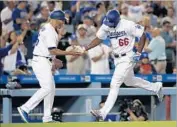 ?? Christian K. Lee Los Angeles Times ?? THE DODGERS’ Yasiel Puig rounds the bases after hitting a fourth-inning home run Friday night.