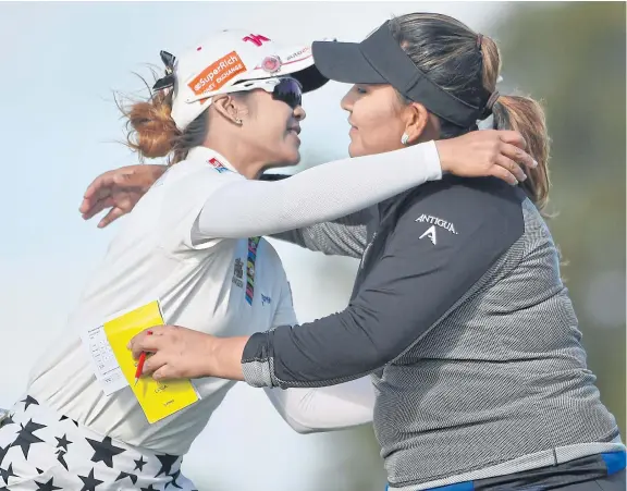  ??  ?? Lizette Salas, right, hugs Pornanong Phatlum at the end of the third round at Royal Adelaide.
