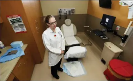  ?? THE ASSOCIATED PRESS ?? Dr. Lindsey Fish waits for a patient in a procedure room in Denver Health Medical Center’s primary care clinic located in a low-income neighborho­od in southwest Denver. Under the new GOP health care proposal, which could roll back Medicaid expansion...