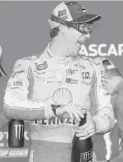  ?? CHRIS GRAYTHEN/GETTY ?? Joey Logano celebrates after NASCAR Cup Series Championsh­ip race at Homestead-Miami Speedway.