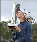  ?? PHELAN M. EBENHACK / AP ?? Jessica Korda kisses the championsh­ip trophy on the 18th green after winning in a one-hole playoff Sunday against Danielle Kang during the final round of the Tournament of Champions in Lake Buena Vista, Fla.