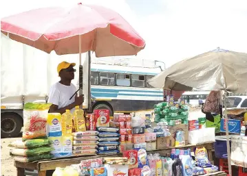  ??  ?? This unidentifi­ed man sells goods at an undesignat­ed point in Mbare yesterday without protective clothing and observing some WHO regulation­s