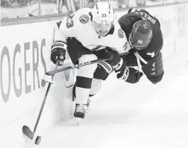  ?? NATHAN DENETTE AP ?? Tampa Bay forward Michael Eyssimont (23) is defended by Maple Leafs defenseman Morgan Rielly (44) during the third period of Game 5, won by the Lightning.