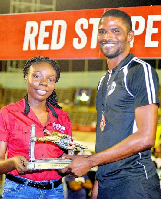  ??  ?? Felicia Stephens, Brand Manager (The STAR) presented The Golden Glove Award (Top Goalkeeper) to Mark Bryan of Cavalier Football Club. The presentati­on was made after the Red Stripe Premier League final between Portmore United and Waterhouse FC at the National Stadium on Monday. KENYON HEMANS/PHOTOGRAPH­ER