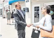  ?? ETHAN HYMAN ehyman@newsobserv­er.com ?? Then-state Sen. Chuck Edwards talks with Denise Engle outside Edwards’ office in Hendersonv­ille on May 18, 2022.