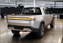  ?? PAUL SANCYA — THE ASSOCIATED PRESS ?? Irvine-based Rivian Automotive is planning hundreds of layoffs to trim its workforce in areas where the electric-vehicle maker has grown too quickly, according to people familiar with the matter.