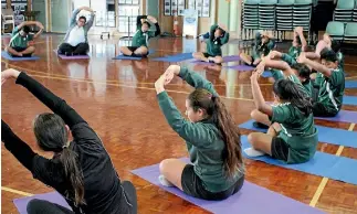  ?? PHOTO: SUPPLIED ?? Avalon Intermedia­te students stretch during their Yoga in Schools lesson.