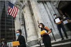  ?? AP FILE PHOTO/
EDUARDO MUNOZ ALVAREZ ?? In this July 11 file photo, mourners carry out the remains of loved ones following the blessing of the ashes of Mexicans who died from COVID-19 at St. Patrick’s Cathedral in New York.