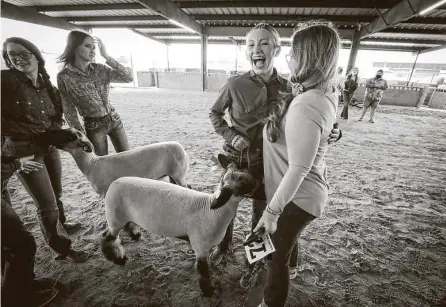  ?? Steve Gonzales / Staff photograph­er ?? Brooklyn Anderson from Deer Park Junior High, center, was ecstatic as she hugged family friend Christina Bell after her sheep, Aggie, placed first during the Pasadena Livestock Show on Sunday in Pasadena.