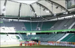  ?? KAI PFAFFENBAC­H — POOL PHOTO VIA AP ?? Munich’s players celebrate in front of the empty stands after the German Bundesliga soccer match between VfL Wolfsburg and FC Bayern Munich in Wolfsburg, Germany on Saturday.