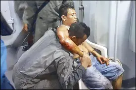  ?? EPA ?? A handout picture made available by the Malaysian Maritime Enforcemen­t Force Agency shows its personnel helping an injured Indonesian, one of four sailors kidnapped by unidentifi­ed gunmen in Tawi-Tawi on Friday.