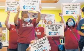  ?? SHAFKAT ANOWAR/AP ?? Members of the Health Illinois coalition in Chicago’s Pilsen neighborho­od celebrate the extension Tuesday of state health insurance coverage to immigrants 55 and over living in the country illegally. The state was the first to offer a program for seniors.