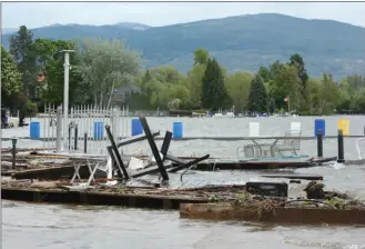  ?? GARY NYLANDER/The Daily Courier ?? The rising level of Okanagan Lake in May and early June damaged and destroyed docks along the shore, including these ones near Beach Avenue. Some of the docks may have been illegal in that they obstructed public access along the foreshore or beach, and...