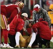  ?? ?? The 49ers' Deebo Samuel gets help from medical personnel after suffering a shoulder injury in the first quarter of the NFC divisional playoff game agaimst the Packers on Saturday.