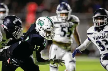  ??  ?? Spring running back Joey Fussell Jr. (17) battles through Tomball Memorial defenders to score a touchdown during the Lions’ easy victory at Planet Ford Stadium.