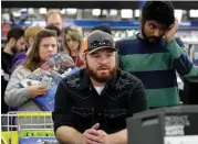  ?? Charlie Riedel / Associated Press ?? Customers wait to check out at a Best Buy on Thanksgivi­ng Day in Overland Park, Kan.