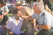  ?? (AP/Will Morris) ?? Col. Malcolm Bruce Westcott, then deputy chief of the Army Reserve, comforts Pentagon employee Racquel Kelley while giving her medical aid outside the Pentagon in Washington on Sept. 11, 2001.