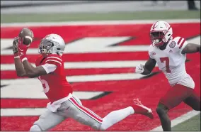  ?? JAY LAPRETE — THE ASSOCIATED PRESS ?? Ohio State receiver Garrett Wilson catches a touchdown pass as Nebraska defensive back Dicaprio Bootle looks on Oct. 24in Columbus.