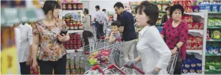  ??  ?? PYONGYANG: In a photo taken on Sunday, shoppers browse products on display at the Kwangbok, or ‘liberation’, department store in Pyongyang. —AFP