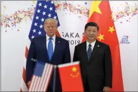  ?? (AP/Susan Walsh) ?? In this June 2019 photo, President Donald Trump (left) poses for a photo with Chinese President Xi Jinping during a meeting on the sidelines of the G-20 summit in Osaka, Japan. China has fast become a top election issue as Trump and Democrat Joe Biden spar over who’s better at playing the tough guy against Beijing.