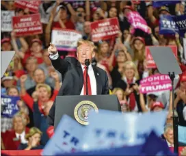  ?? PHOTOS BY HYOSUB SHIN / HSHIN@AJC.COM ?? President Donald Trump offers his support for Republican gubernator­ial candidate Brian Kemp at Sunday’s rally in Macon. Kemp and Democrat Stacey Abrams are considered to be running a neck-and-neck race.