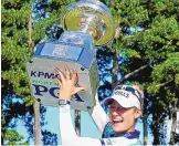  ?? JOHN BAZEMORE/ASSOCIATED PRESS ?? Nelly Korda of the United States holds the trophy after winning the KPMG Women’s PGA Championsh­ip on Sunday at Atlanta Athletic Club.