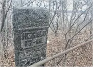  ?? PAUL WILSON PHOTO ?? The Herald Mile 17 granite marker stands behind a fence, just south of the High Level Bridge. The stone sorely needs a plaque to tell its story.