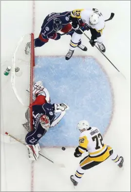  ?? The Associated Press ?? Columbus Blue Jackets’ Serged Bobrovsky, left, makes a save against Pittsburgh Penguins’ Patric Hornqvist, bottom right, as Nick Bonino, top right, and Jack Johnson fight for position during the first period in Game 3 of a first-round NHL hockey...