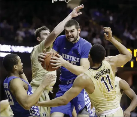  ?? MARK HUMPHREY — THE ASSOCIATED PRESS FILE ?? Kentucky forward Isaac Humphries, center, grabs a rebound in front of Vanderbilt’s Luke Kornet, second from left, and Jeff Roberson (11) during the first half of an NCAA college basketball game on Jan. 10, 2017, in Nashville, Tenn. Humphries has announced that he is gay and said he hopes his decision to publicly announce his sexuality will lead to more profession­al sportsmen doing the same.