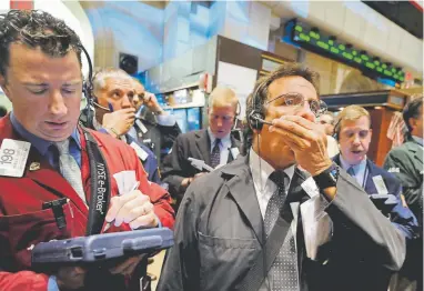  ?? Richard Drew, Associated Press file photo ?? Traders react on the New York Stock Exchange floor on Oct. 6, 2008, as a global selloff grew amid fears of a financial crisis.