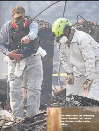  ?? JUSTIN SULLIVAN/GETTY IMAGES ?? Fire crews search the smoldering ruins of Paradise, Calif., where more human remains may be hidden.