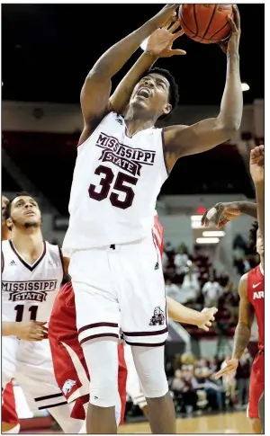  ?? AP/ROGELIO V. SOLIS ?? Mississipp­i State’s Aric Holman (35) grabs a rebound against Arkansas during the Bulldogs’ victory Tuesday night in Starkville, Miss. The Bulldogs finished with 17 offensive rebounds in their 78-75 victory. “We had a problem rebounding,” Arkansas guard...