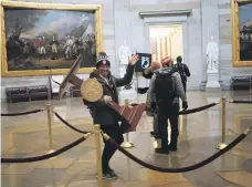  ?? AFP ?? A man later identified as Adam Johnson with the lectern of House Speaker Nancy Pelosi during the January 6 riot