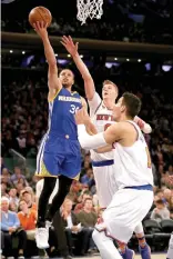  ??  ?? STEPHEN CURRY #30 of the Golden State Warriors heads for the net as Kristaps Porzingis #6 and Willy Hernangome­z #14 of the New York Knicks defend at Madison Square Garden on March 5 in New York City.