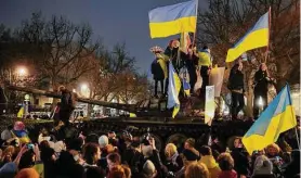  ?? Markus Schreiber/Associated Press ?? People wave Ukrainian flags during a demonstrat­ion to mark the first anniversar­y of Russia’s invasion of Ukraine, in Berlin, Germany, on Friday.