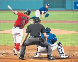  ?? KATHRYN RILEY GETTY IMAGES ?? The Red Sox’s Xander Bogaerts singles up the middle, part of a four-run first inning against Nate Pearson and the Jays at Fenway Park on Tuesday night. The Jays rallied, however, for an 8-6 win.