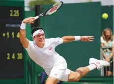  ?? AP ?? Milos Raonic stretches for a forehand shot against Dennis Novak on the sixth day in London.