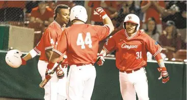  ?? Juan DeLeon ?? Houston catcher Jacob Campbell, right, celebrates with teammates after slugging a three-run homer in the third inning of a 13-1 victory over Villanova on Friday night at Schroeder Park.