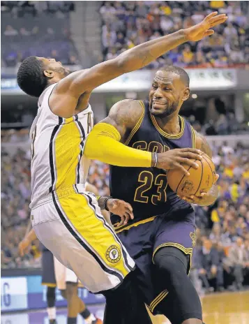  ?? MATT KRYGER, THE INDIANAPOL­IS STAR ?? LeBron James, driving against the Pacers’ Paul George, had a huge series to lead the Cavaliers, who closed the season with a 9- 13 slump, to a first- round sweep.