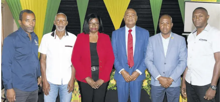  ?? (Photo: Joseph Wellington) ?? President Michael Ricketts (third right) and some of his slate members — (from left) Rudolph Speid, Baron Watson, Elaine Walker-brown, Raymond Grant, and Gregory Daley — share a photo op during the Ricketts Team’s manifesto launch in Clarendon in January.