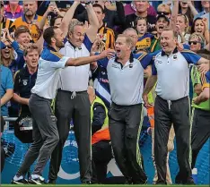  ??  ?? FOUR TOPS: Tipperary boss Michael Ryan (second from left) greets the final whistle with his backroom team